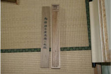 畳の上に細長く文字の書かれた木の板が二枚並べて置かれている写真